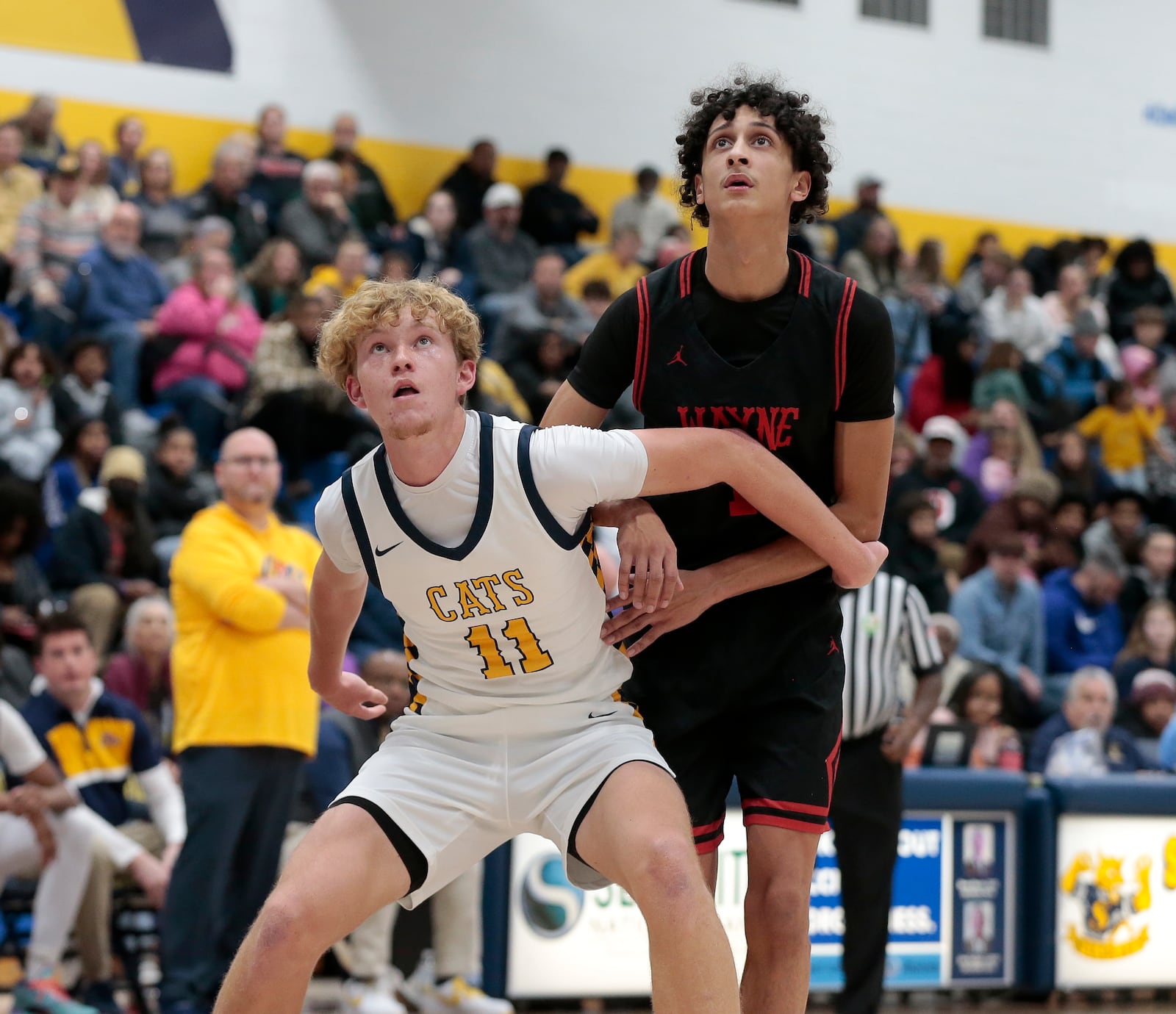 Springfield High School junior Preston Burkhardt boxes out Wayne senior Kaden Post during their Greater Western Ohio Conference game on Friday, Jan. 2, 2026 at Springfield High School. The Warriors won 55-42. STEVEN WRIGHT / STAFF