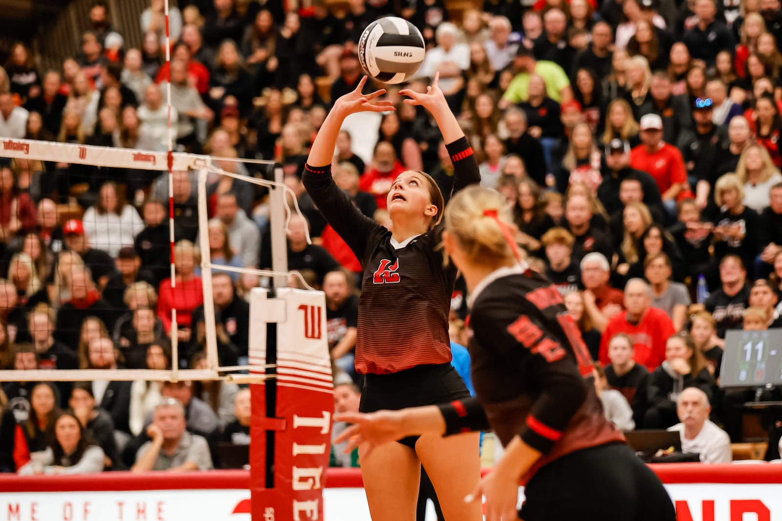 Tippecanoe High School senior Bri Morris sets the ball during their Division III state semifinal match against Akron Hoban on Friday, Nov. 7 at Wittenberg University's Pam Evans Smith Arena in Springfield. The Red Devils won 3-0. MICHAEL COOPER / STAFF PHOTO