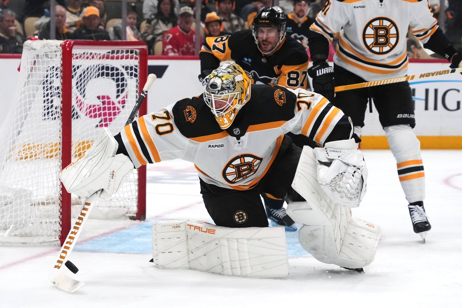Boston Bruins goaltender Joonas Korpisalo (70) tries to control a rebound during the second period of an NHL hockey game against the Pittsburgh Penguins in Pittsburgh, Sunday, April 13, 2025. (AP Photo/Gene J. Puskar)