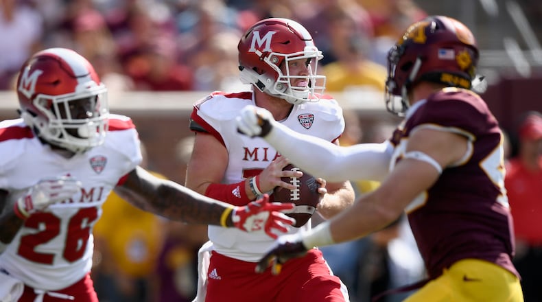Gus Ragland #14 of the Miami RedHawks looks to pass the ball against the Minnesota Golden Gophers during the first quarter of the game on September 15, 2018 at TCF Bank Stadium in Minneapolis, Minnesota. (Photo by Hannah Foslien/Getty Images)