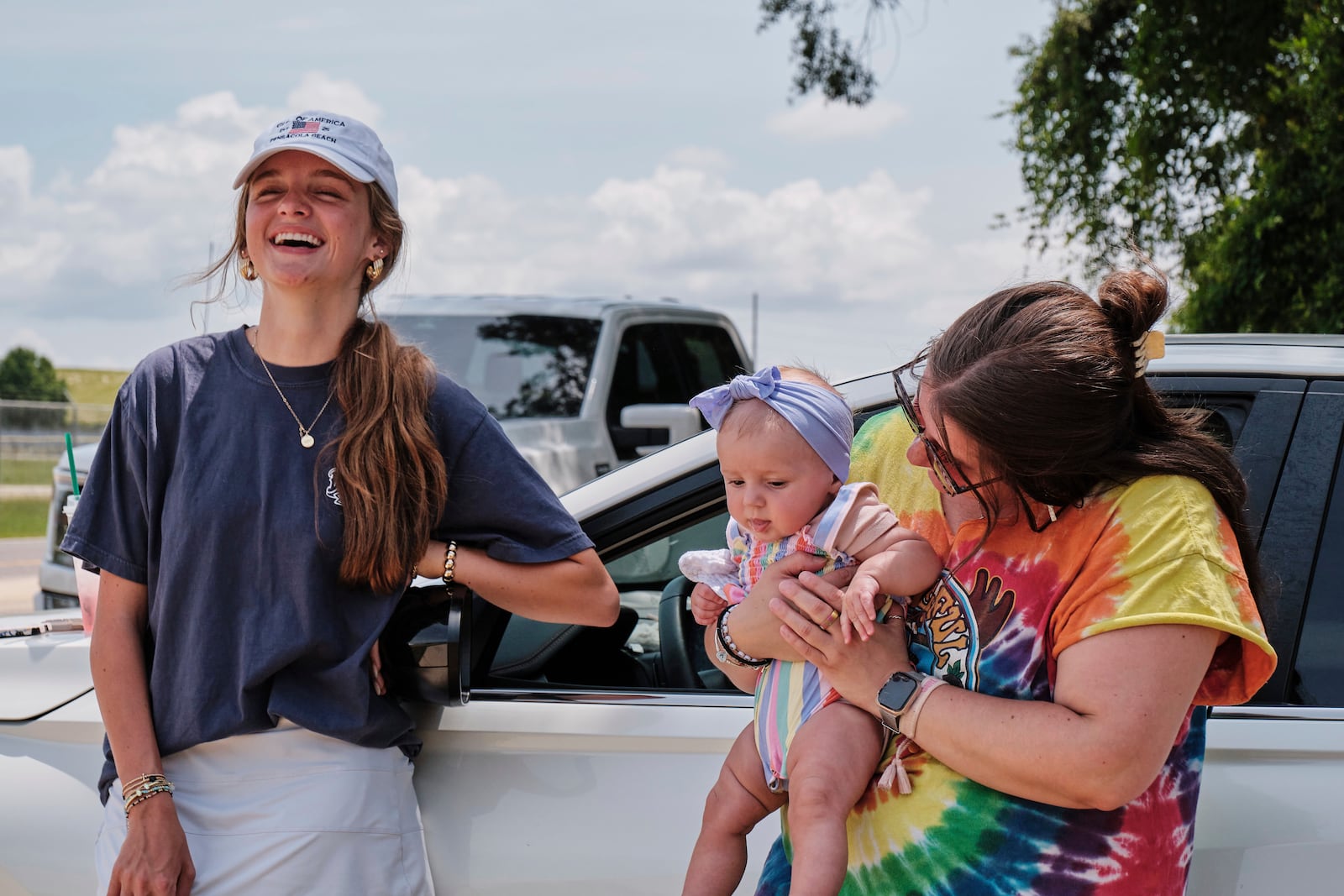 Fans Emma Touchstone, 17, left, and Kelsey Heath with her four-month-old daughter Maggie Fields wait for reality television star Todd Chrisley walks out of the Federal Prison Camp, Wednesday, May 28, 2025, in Pensacola, Fla. (AP Photo/Dan Anderson)