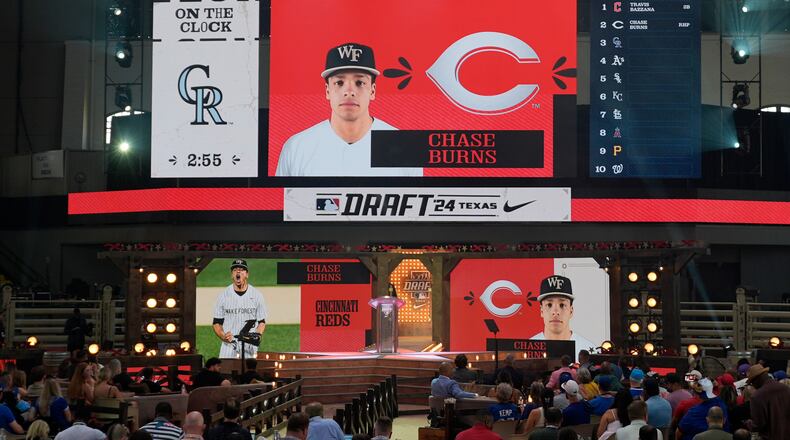 A photo of Chase Burns is shown on the large video board after he was selected by the Cincinnati Reds in the first round of the MLB baseball draft in Fort Worth, Texas, Sunday, July 14, 2024. (AP Photo/LM Otero)