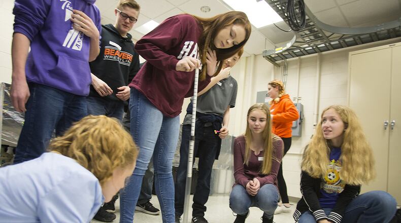 Air Force Institute of Technology Demo Days participants prepare to launch a small rocket, after setting trajectory and power, in a competition for distance and accuracy Feb. 21, 2018 on Wright-Patterson Air Force Base, Ohio. Groups of local high and middle school students moved among stations being exposed to subjects such as robotics, civil engineering, magnetics and electricity. (U.S. Air Force photo by R.J. Oriez)