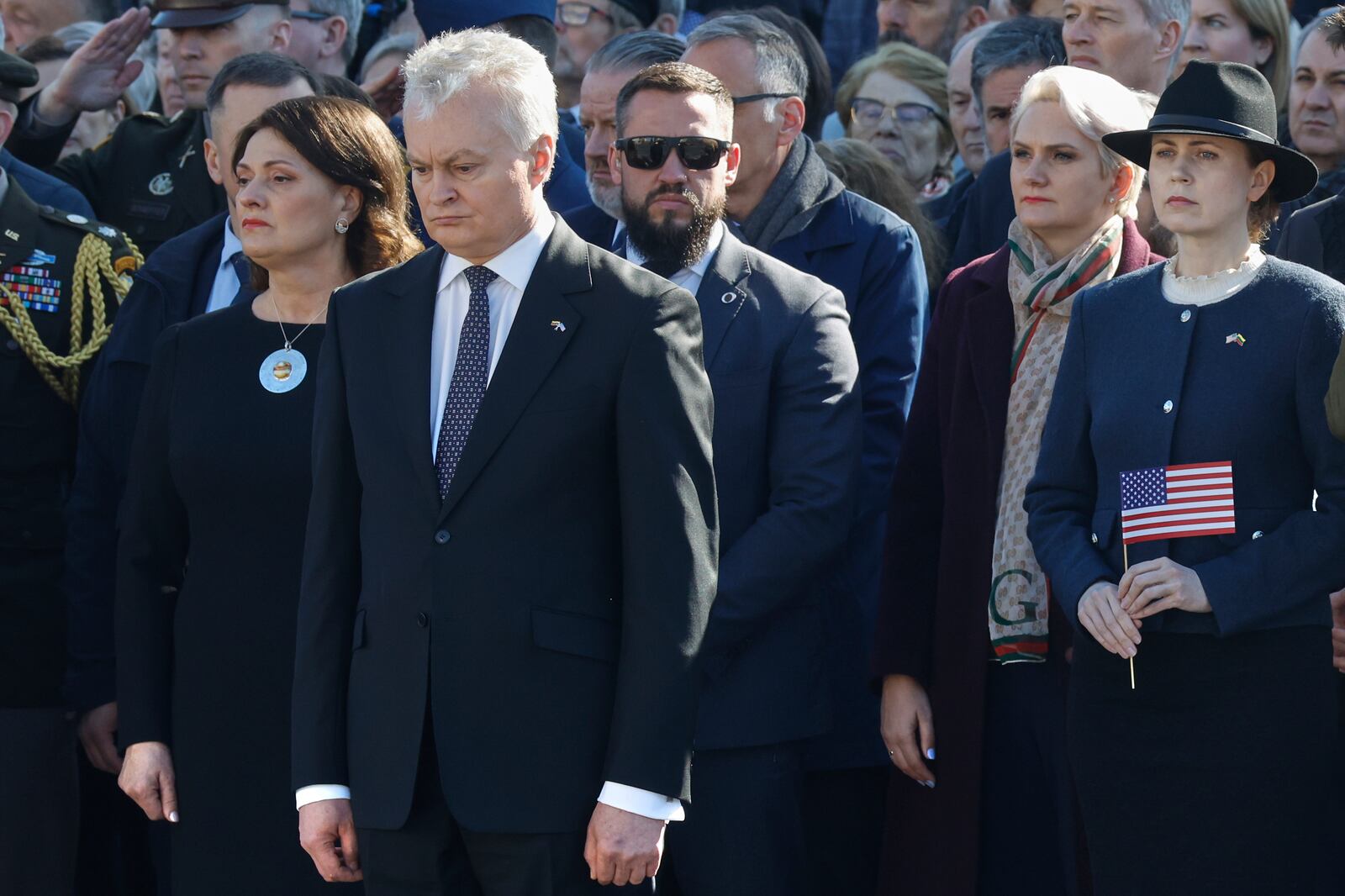 Lithuania's President Gitanas Nauseda, front, attends a solemn farewell ceremony at Cathedral Square in Vilnius, Lithuania, Thursday, April 3, 2025 for the US soldiers who died during training exercise. (AP Photo/Mindaugas Kulbis)