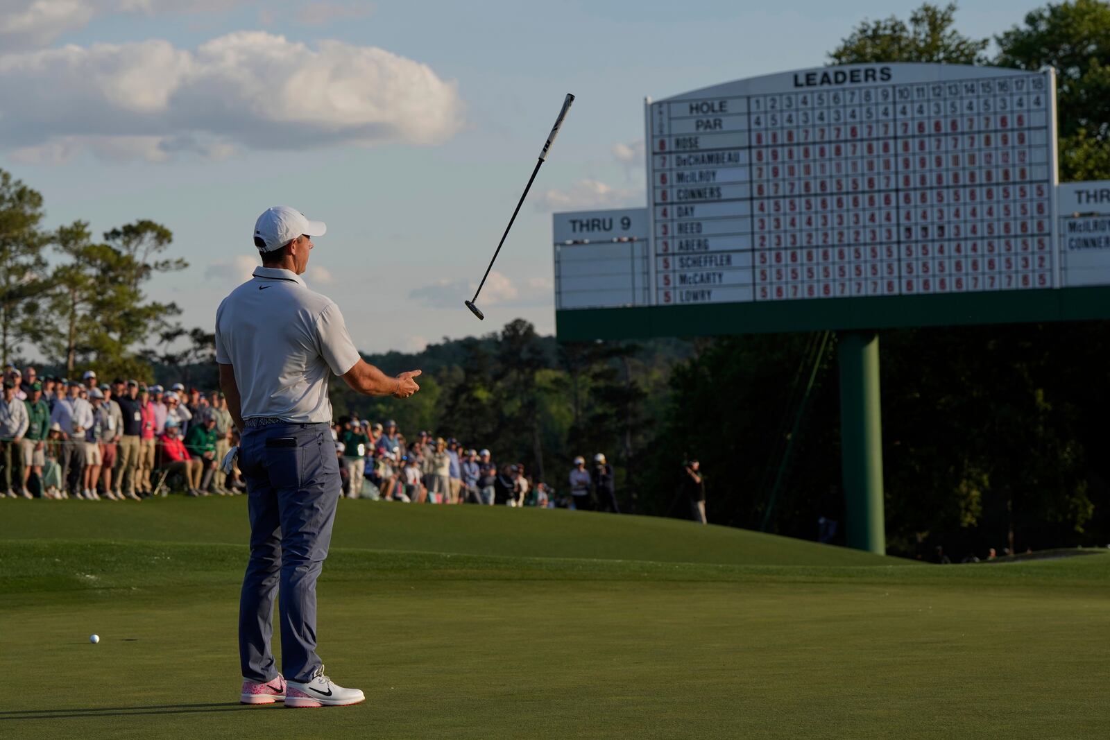 Rory McIlroy, of Northern Ireland, tosses his putter on the 18th hole during the third round at the Masters golf tournament, Saturday, April 12, 2025, in Augusta, Ga. (AP Photo/David J. Phillip)