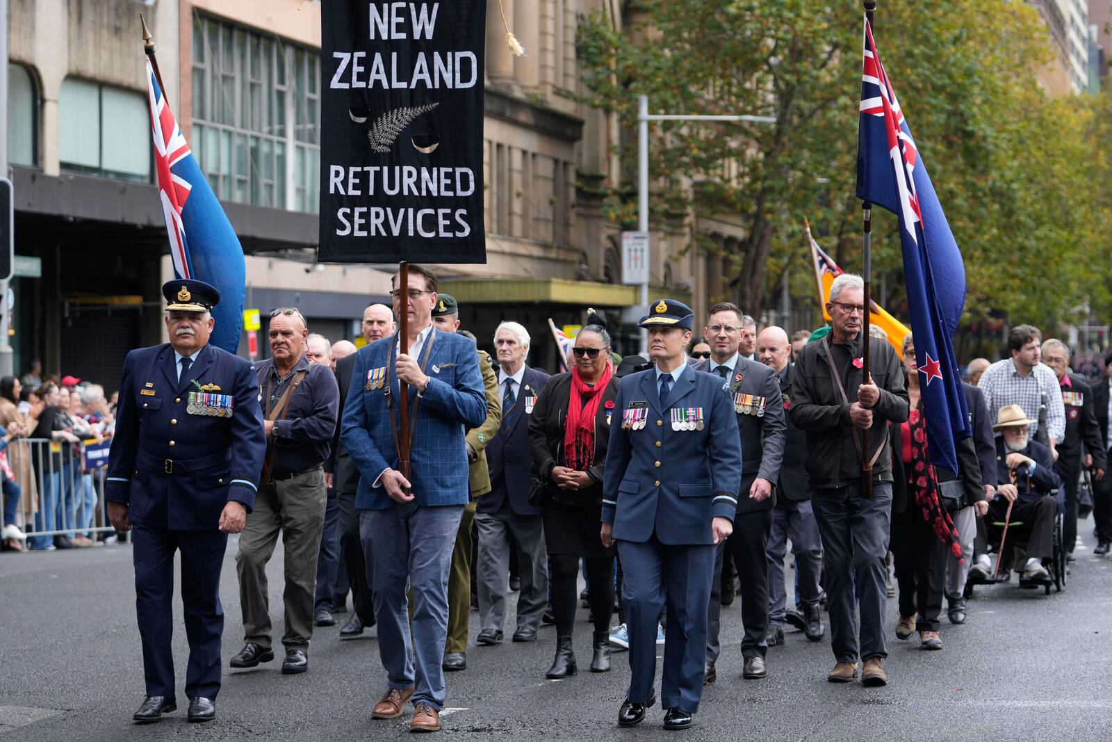 New Zealand participants march past thousands of people lining the street to pay tribute to their war dead during the Anzac Day parade in Sydney, Australia, Friday, April 25, 2025. (AP Photo/Rick Rycroft)