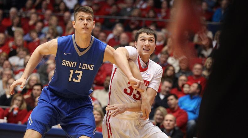Dayton’s Ryan Mikesell, right, blocks out against Matt Neufeld, of Saint Louis, on Wednesday, Jan. 27, 2016, at UD Arena in Dayton. David Jablonski/Staff