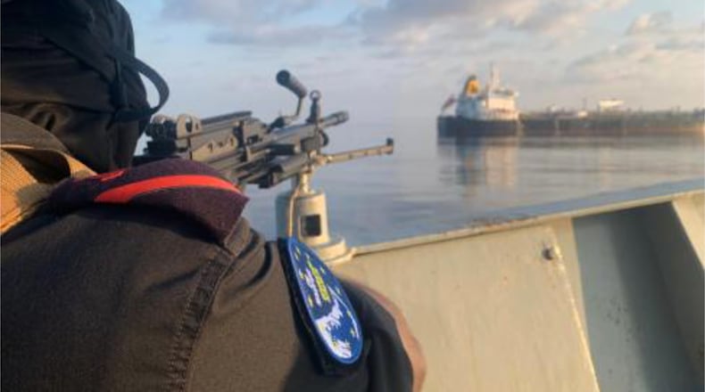 A member of the European Union's Operation Atalanta mans a machine gun aboard the ESPS Victoria while watching the Hellas Aphrodite off the coast of Somalia in the Arabian Sea on Friday, Nov. 7, 2025. (European Union's Operation Atalanta via AP)