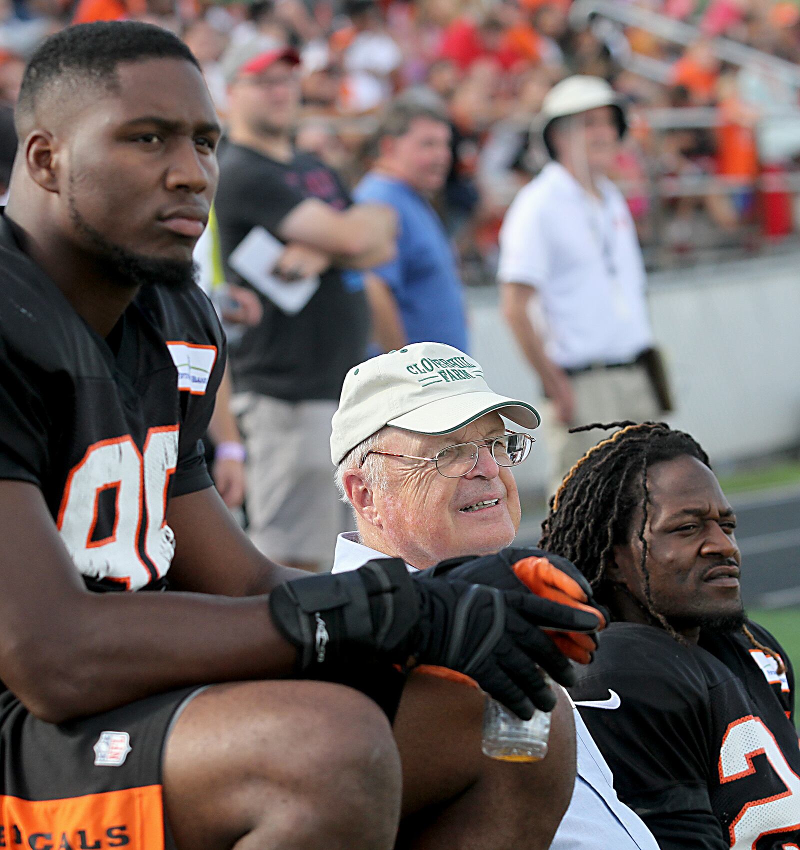 Contributed photo by E.L. Hubbard Bengals owner and president, Mike Brown, center, rides the bench between players Carlos Dunlap and Adam Jones during practice at West Carrollton High School Sunday, August 21, 2016.