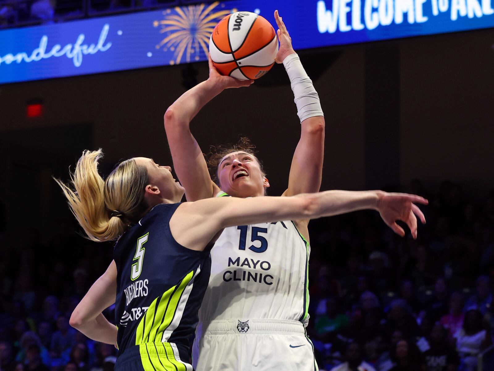 Dallas Wings guard Paige Bueckers (5) fouls Minnesota Lynx forward Jessica Shepard (15) who shoots in the second half of a WNBA basketball game Friday, May 16, 2025, in Arlington, Texas. (AP Photo/Richard W. Rodriguez)