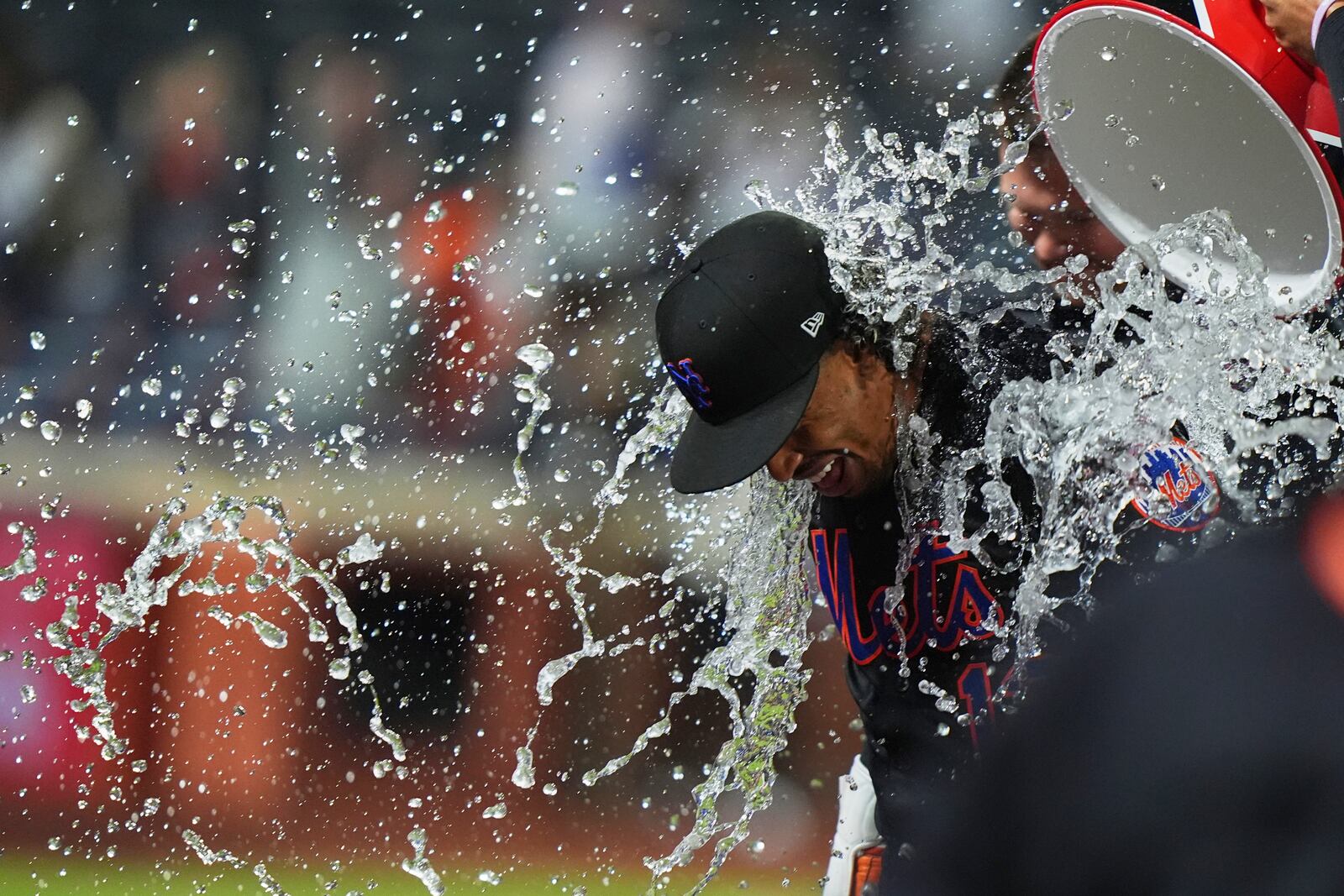 Teammates dunk water on New York Mets' Francisco Lindor after a baseball game against the St. Louis Cardinals Friday, April 18, 2025, in New York. (AP Photo/Frank Franklin II)