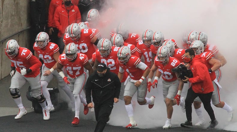 Ohio State coach Ryan Day leads the team onto the field before a game against Indiana on Saturday, Nov. 22, 2020, at Ohio Stadium in Columbus. David Jablonski/Staff