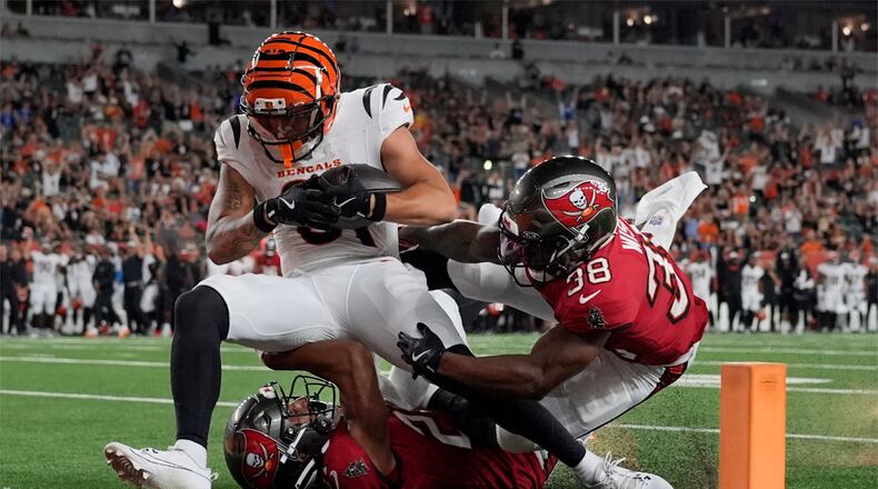Cincinnati Bengals wide receiver Jermaine Burton, top left, scores a touchdown ahead of Tampa Bay Buccaneers safety Rashad Wisdom (38) in the second half of an NFL preseason football game Saturday, Aug. 10, 2024, in Cincinnati. (AP Photo/Carolyn Kaster)