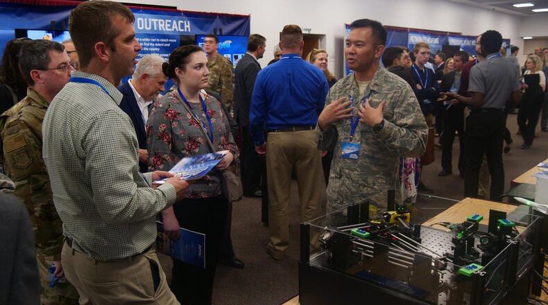 2nd Lt. J.D. Vela Cruz, a laser weapons and aerodynamics engineer from the Air Force Research Laboratory’s Directed Energy Directorate, explains how directed energy amplifies speed, range, precision and accuracy to attendees at the AFRL 2019 Tech Expo event. (U.S. Air Force photo/Kevin Lewis)