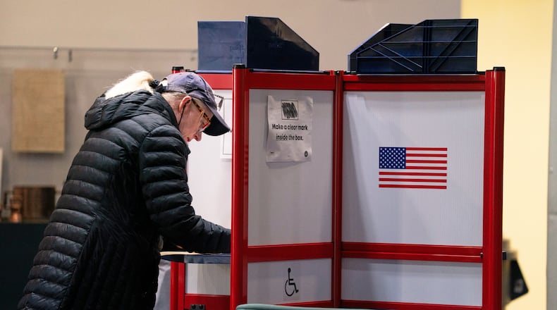 A voter completes her ballot at Alexandria City Hall, Tuesday, Nov. 4, 2025, in Alexandria, Va. (AP Photo/Allison Robbert)