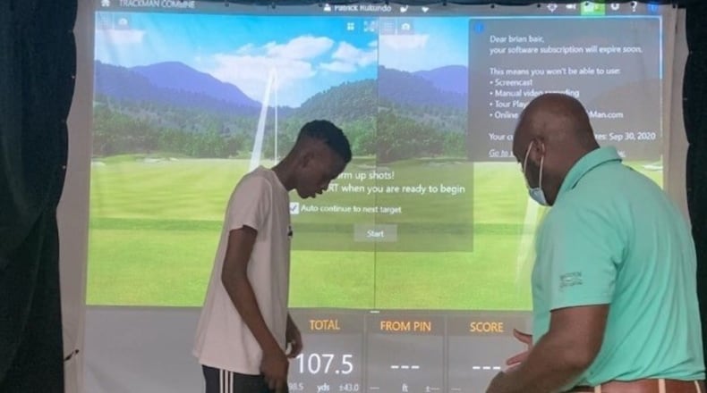 Wilberforce golf coach William Ware with budding Patrick Rukundo, a freshman out of Dayton Dunbar, at a golf simulator. CONTRIBUTED
