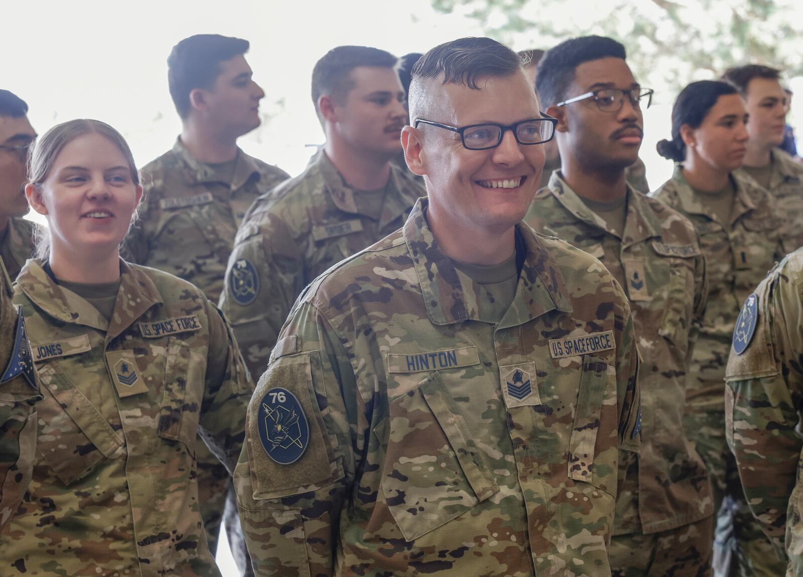 Logan Hinton, technical sergeant with U.S. Space Force, laughs as a speaker makes a joke during a ribbon-cutting ceremony for the opening of a new U.S. Space Force Combined Intelligence Operations floor, the Space Intelligence Production Cell, on Friday, September 26, 2025, in Springfield. JOSEPH COOKE/STAFF