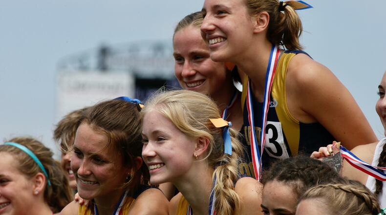 Oakwood's 3,200-meter relay team stands atop the podium after winning at Division II state championship on Friday, June 4, 2021, at Pickerington North High School. David Jablonski/Staff
