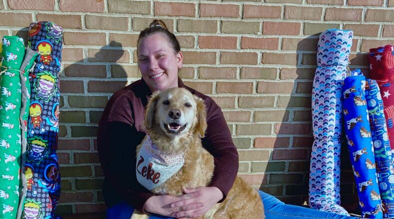 Stephanie and Zeke sitting comfortably on a pet mat. PROVIDED