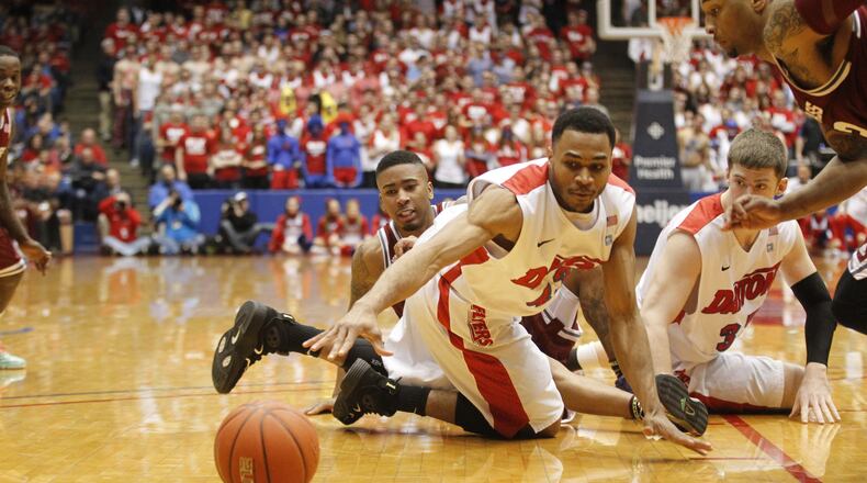 Dayton guard Vee Sanford reaches for a loose ball against Massachusetts on Saturday, March 1, 2014, at UD Arena. David Jablonski/Staff