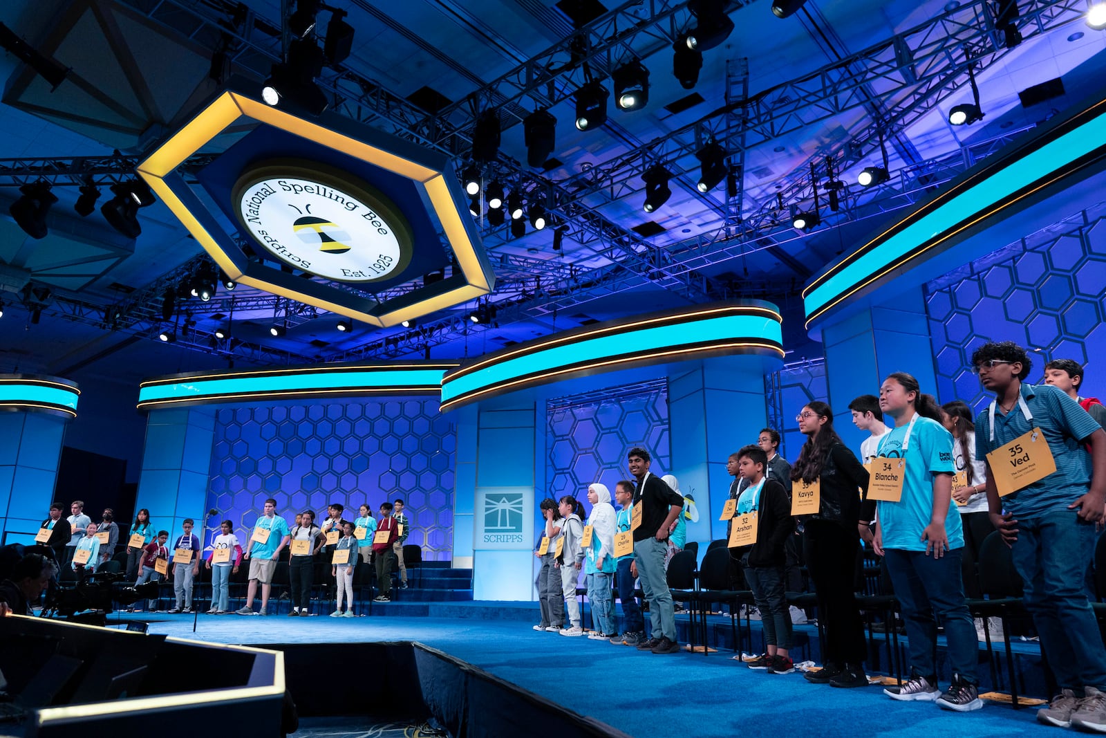 Participants stand up as they compete during the first preliminary round of the Scripps National Spelling Bee at the Gaylord National Resort & Convention Center, Tuesday, May 27, 2025, in Oxon Hill, Md. (AP Photo/Jose Luis Magana)