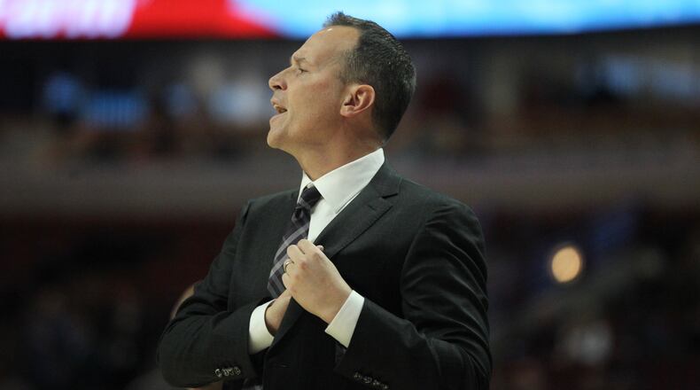 Northwestern coach Chris Collins talks to his team during a game against Dayton. David Jablonski/Staff