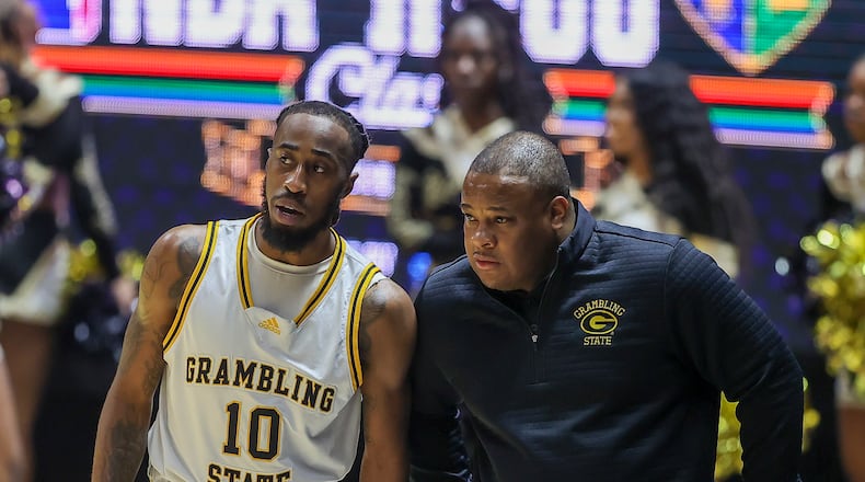 Grambling State guard Shawndarius Cowart (10) and head coach Donte' Jackson speak while Southern takes free throws in the first half of the NBA All-Star HBCU classic college basketball game Saturday, Feb. 18, 2023, in Salt Lake City. (AP Photo/Rob Gray)