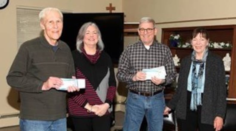 100+ Women Making a Difference in Greene County present a check to the St Vincent De Paul group at Mary Help of Christians church in Fairborn for their food pantry. Pictured left to right are JC Kelly, Rebecca Morgann, Tom Boland, Sandy McHugh. CONTRIBUTED