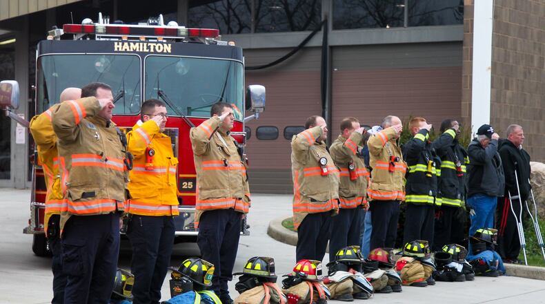 The funeral procession for Hamilton firefighter Patrick Wolterman passes by his fire station Thursday, Dec. 31. Wolterman died from injuries he sustained when he fell through the first floor of a home into the basement while battling a fire on Pater Avenue early Monday morning. GREG LYNCH/FILE