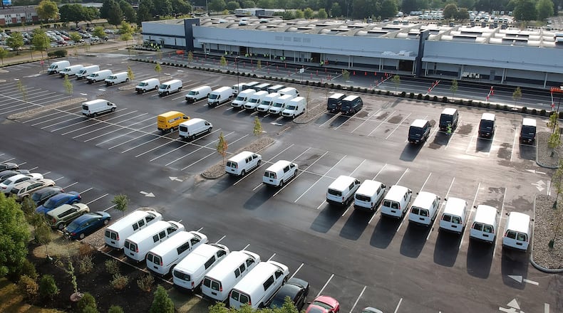 Amazon is ramping up its operation in the Kettering Business Park. Delivery vans have been filling the parking lots of the distribution center for about three weeks. TY GREENLEES / STAFF