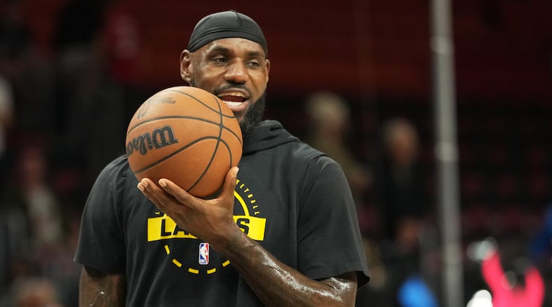 Los Angeles Lakers forward LeBron James warms up before an NBA basketball game against the Miami Heat, Thursday, March 19, 2026, in Miami. (AP Photo/Lynne Sladky)