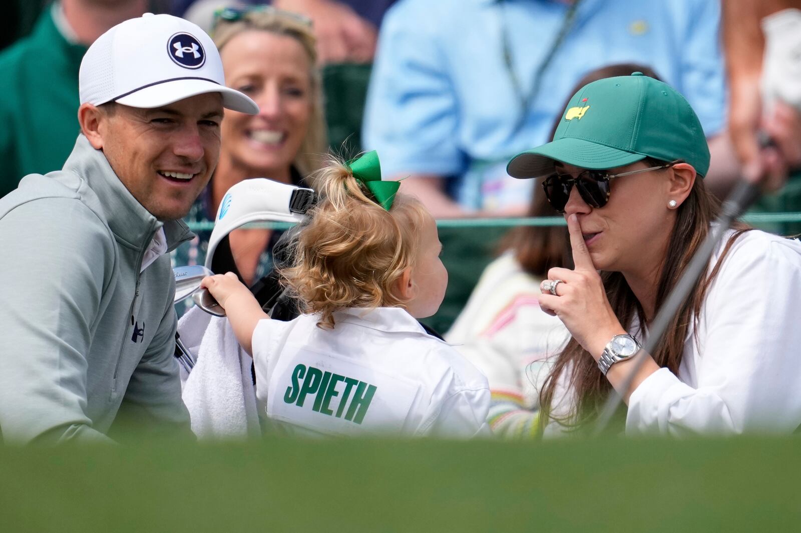 Jordan Spieth and wife Annie Verret interact with daughter Sophie as they wait to play on the first hole during a practice around at the Masters golf tournament, Wednesday, April 9, 2025, in Augusta, Ga. (AP Photo/George Walker IV)