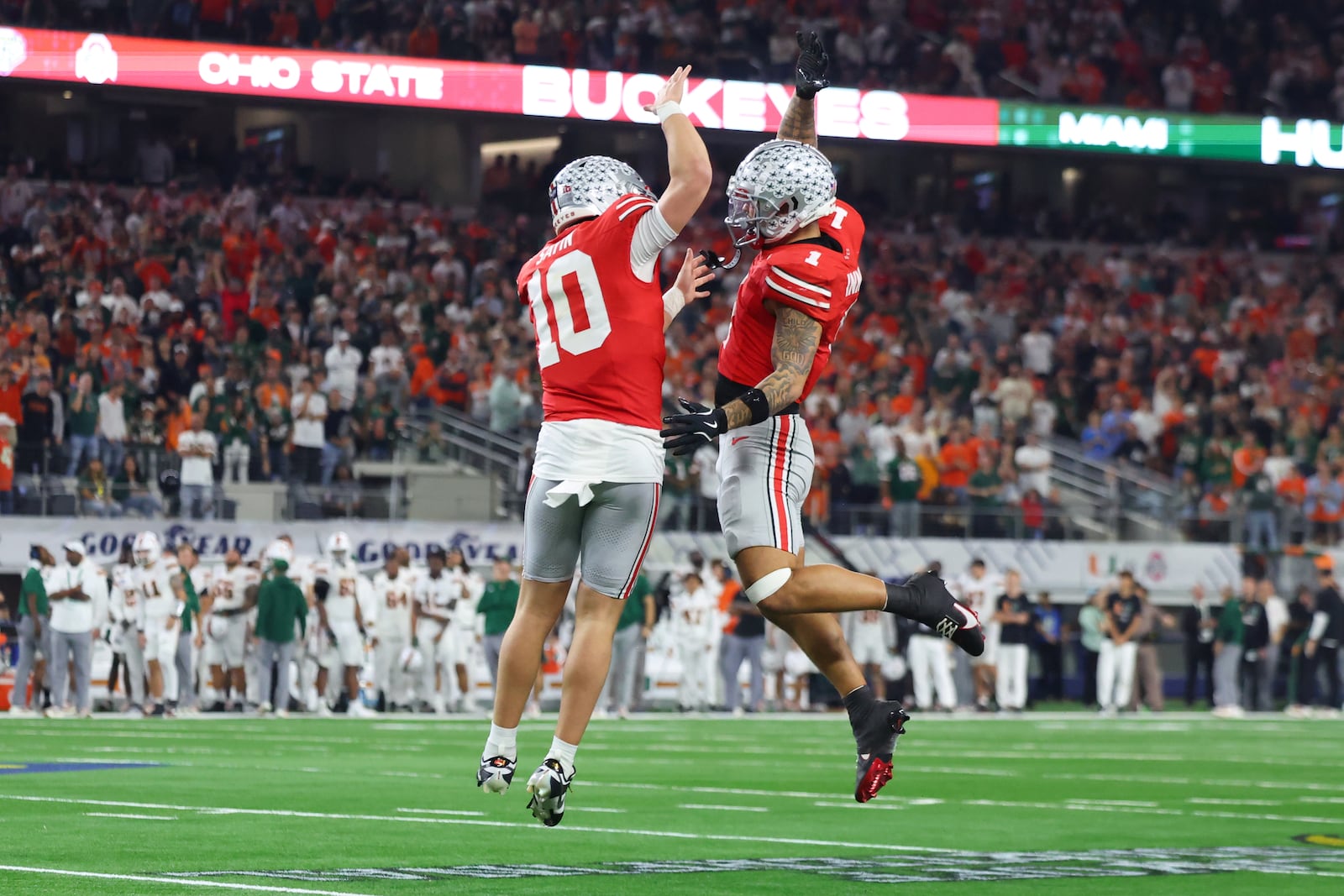 Ohio State quarterback Julian Sayin, left, reacts with wide receiver Brandon Inniss after scoring a touchdown against Miami during the second half of the Cotton Bowl College Football Playoff quarterfinal game Wednesday, Dec. 31, 2025, in Arlington, Texas. (AP Photo/Gareth Patterson)