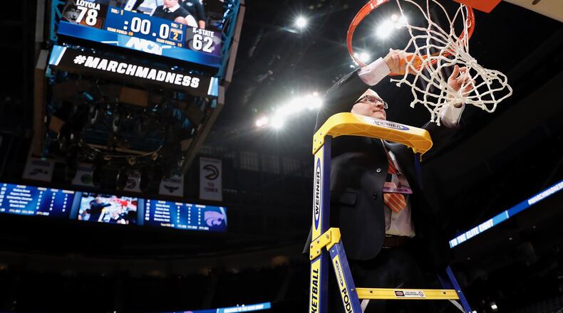 Loyola sports information director Bill Behrns cuts down the net after a victory against Kansas State on Saturday, March 24, 2018, in the South Regional final in Atlanta, Ga. Steve Woltmann/Loyola Athletics