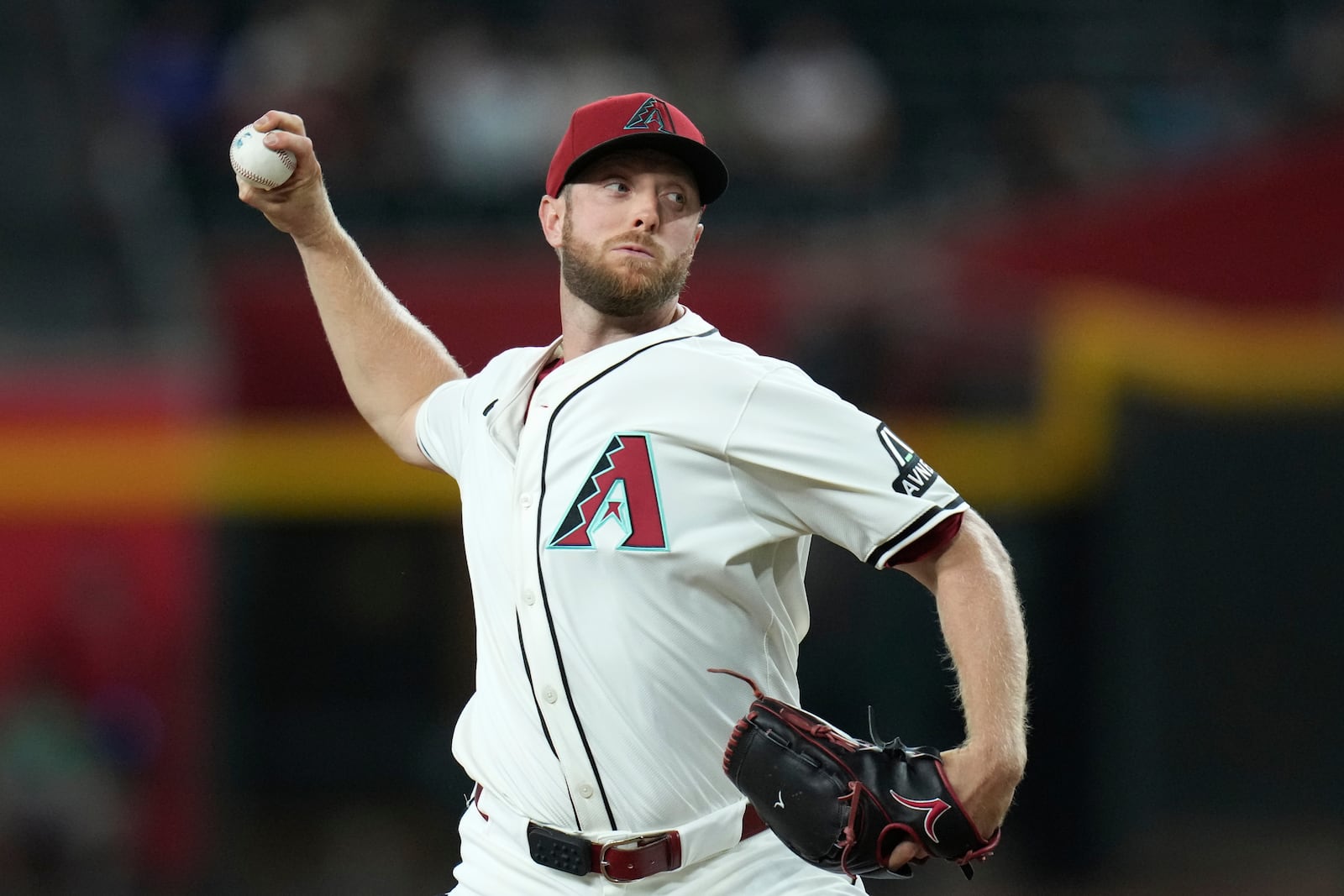 Arizona Diamondbacks starting pitcher Merrill Kelly throws against the St. Louis Cardinals during the first inning of a baseball game Sunday, July 20, 2025, in Phoenix. (AP Photo/Ross D. Franklin)