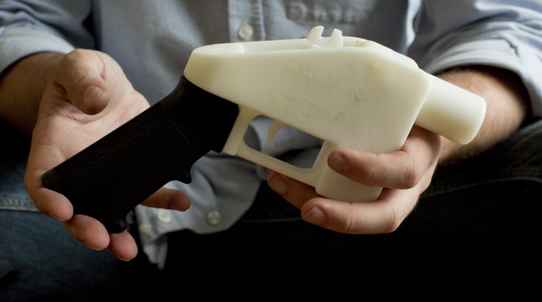 Cody Wilson holds what he calls a Liberator pistol that was completely made on a 3-D-printer at his home in Austin, Texas. Eight states filed suit Monday, July 30, 2018, against the Trump administration over its decision to allow a Texas company to publish downloadable blueprints for a 3D-printed gun, contending the hard-to-trace plastic weapons are a boon to terrorists and criminals and threaten public safety. (Jay Janner/Austin American-Statesman via AP, File)
