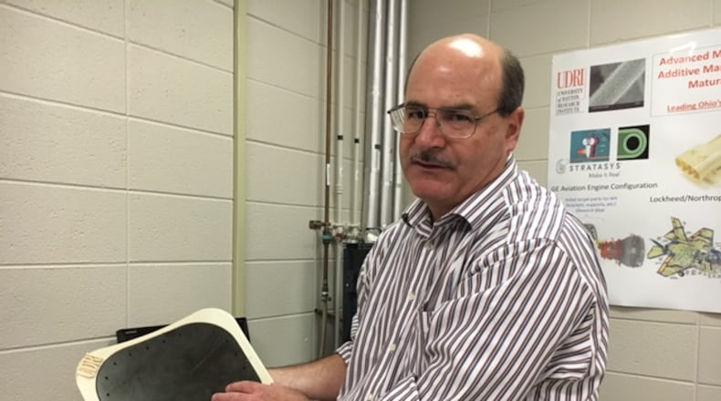 Brian Rice, a materials research engineer at the University of Dayton Research Institute, talks about the additive manufacturing research he and others are performing for the Air Force in a photo taken last year. THOMAS GNAU/STAFF