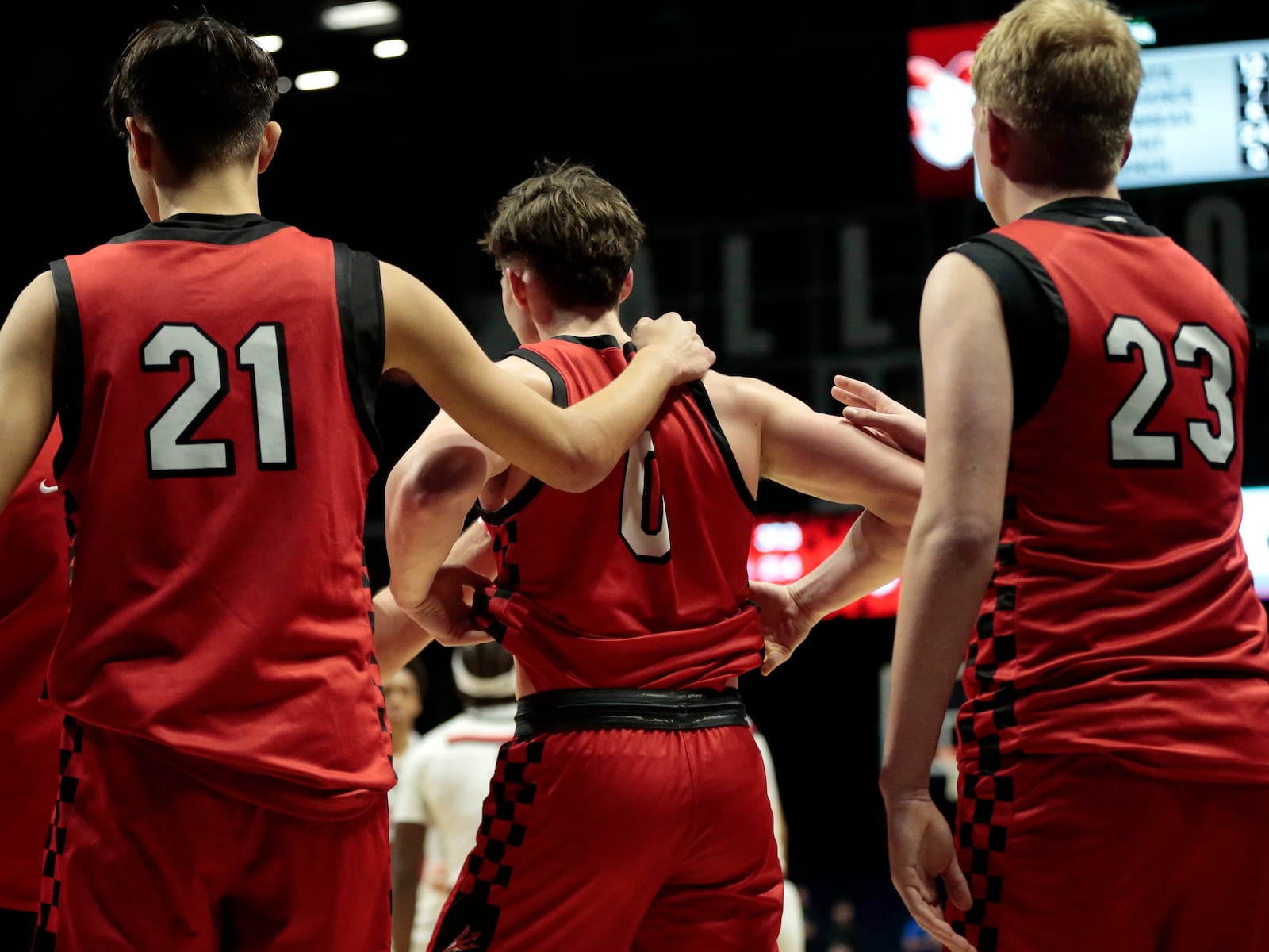 Tippecanoe senior Colin Turner (21) and sophomore Jacob Riffell (23) console senior CJ Bailey (1) following a Division III regional semifinal game Tuesday, March 10, 2026, at the Cintas Center in Cincinnati. Trotwood won 46-44. STEVEN WRIGHT / STAFF