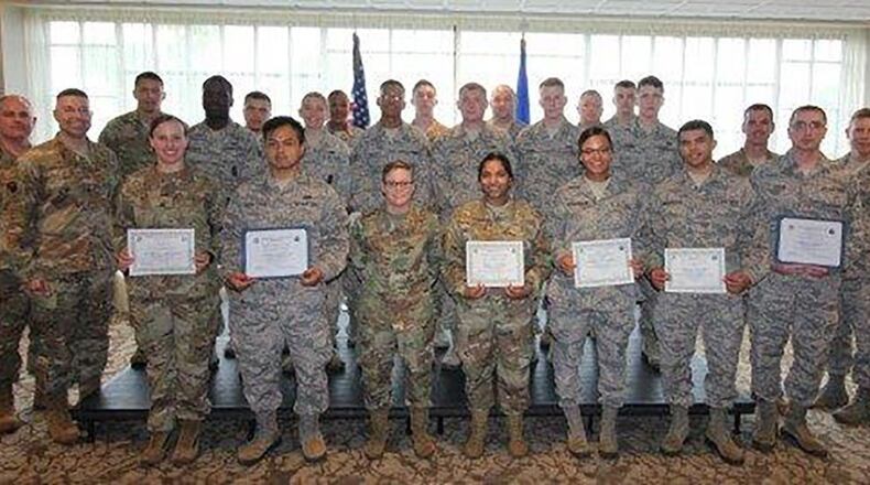Col. Thomas Sherman (second from left), 88th Air Base Wing and installation commander, and Chief Master Sgt. Joseph Newton (right), 88th Mission SuGroup superintendent, pose with the newest Team Wright-Patt enlisted promotees during a ceremony at the Wright-Patterson Club July 31. (U.S. Air Force photo/Thomas Lewis)