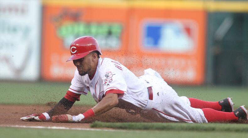 The Reds’ Billy Hamilton steals third base against the Braves on Monday, July 18, 2016, at Great American Ball Park in Cincinnati. David Jablonski/Staff