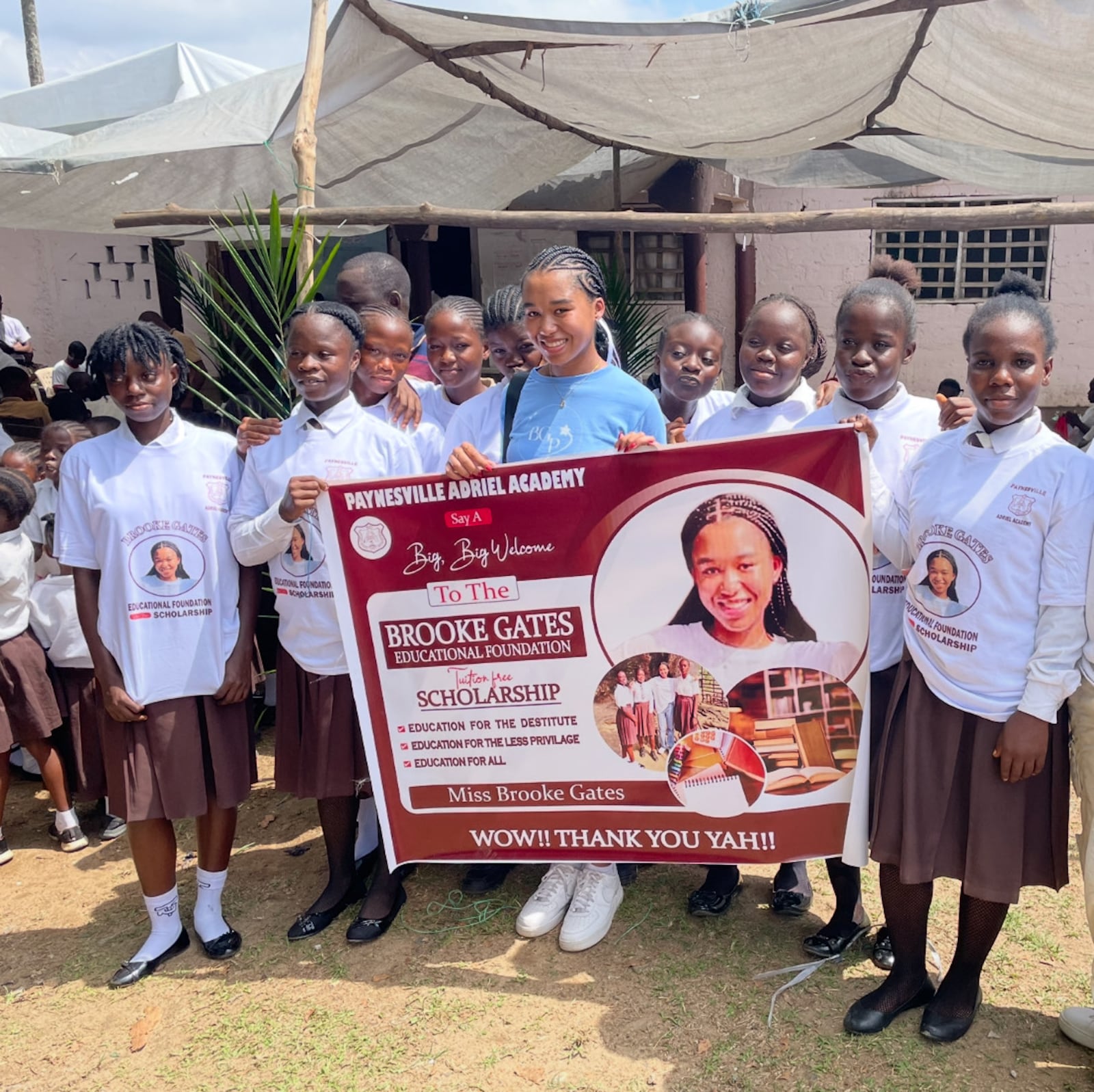 Brooke Gates (center, in blue) with a group of students in Liberia. CONTRIBUTED
