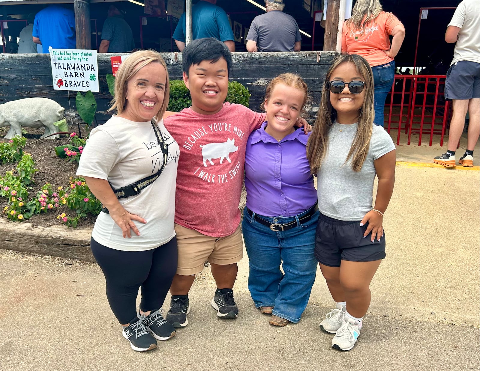 Three members of the "7 Little Johnston" reality TV show family attended the Butler County Fair July 21 and 22 to support Alex Johnston's girlfriends, Allie Smith (purple). TAYLOR STUMBAUGH/STAFF