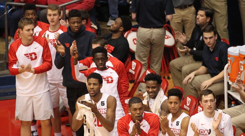 Dayton players celebrate a basket against East Tennessee State on Saturday, Dec. 10, 2016, at UD Arena. David Jablonski/Staff