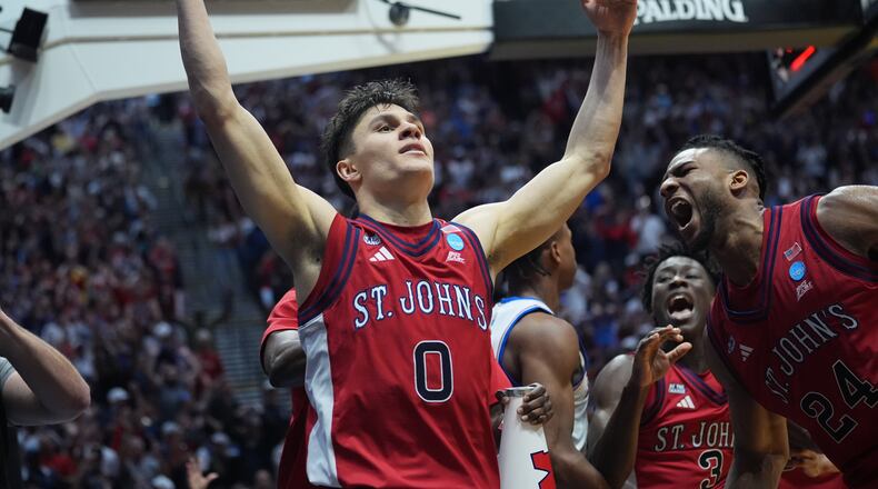 St. John's guard Dylan Darling (0) celebrates after St. John's defeated Kansas in the second round of the NCAA college basketball tournament Sunday, March 22, 2026, in San Diego. (AP Photo/Marcio Jose Sanchez)