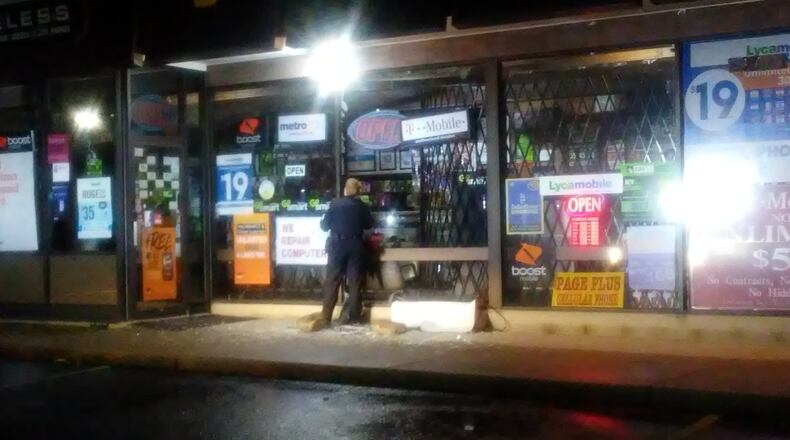 Trotwood police investigate after the Venus Wireless store was targeted by burglars early Tuesday morning. (Desmond Winton-Finklea/Staff)