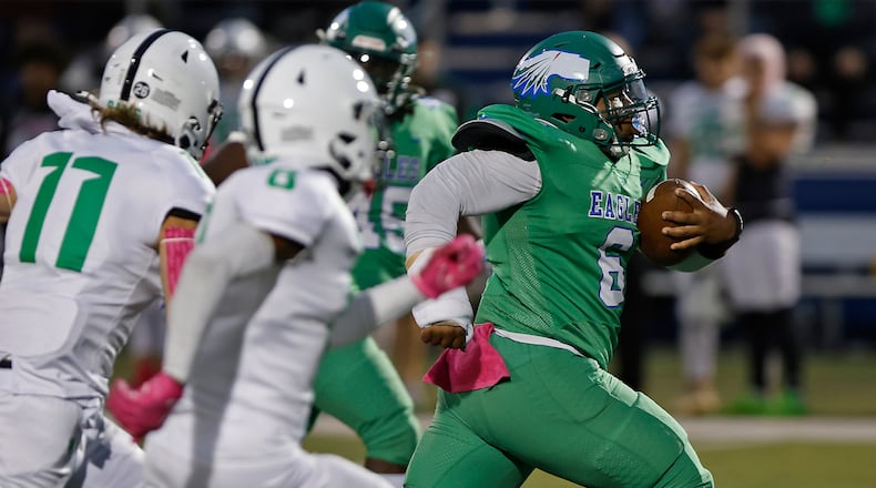 CJ's Nydrell Wright is chased by a pack of Badin defenders as he rushes for a first down during last week's game. BILL LACKEY/STAFF