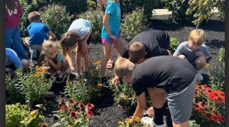 Morgan Elementary School students work in the butterfly garden outside the school. Morgan recently was named a 2024 National Blue Ribbon School by the U.S. Department of Education. SUBMITTED PHOTO