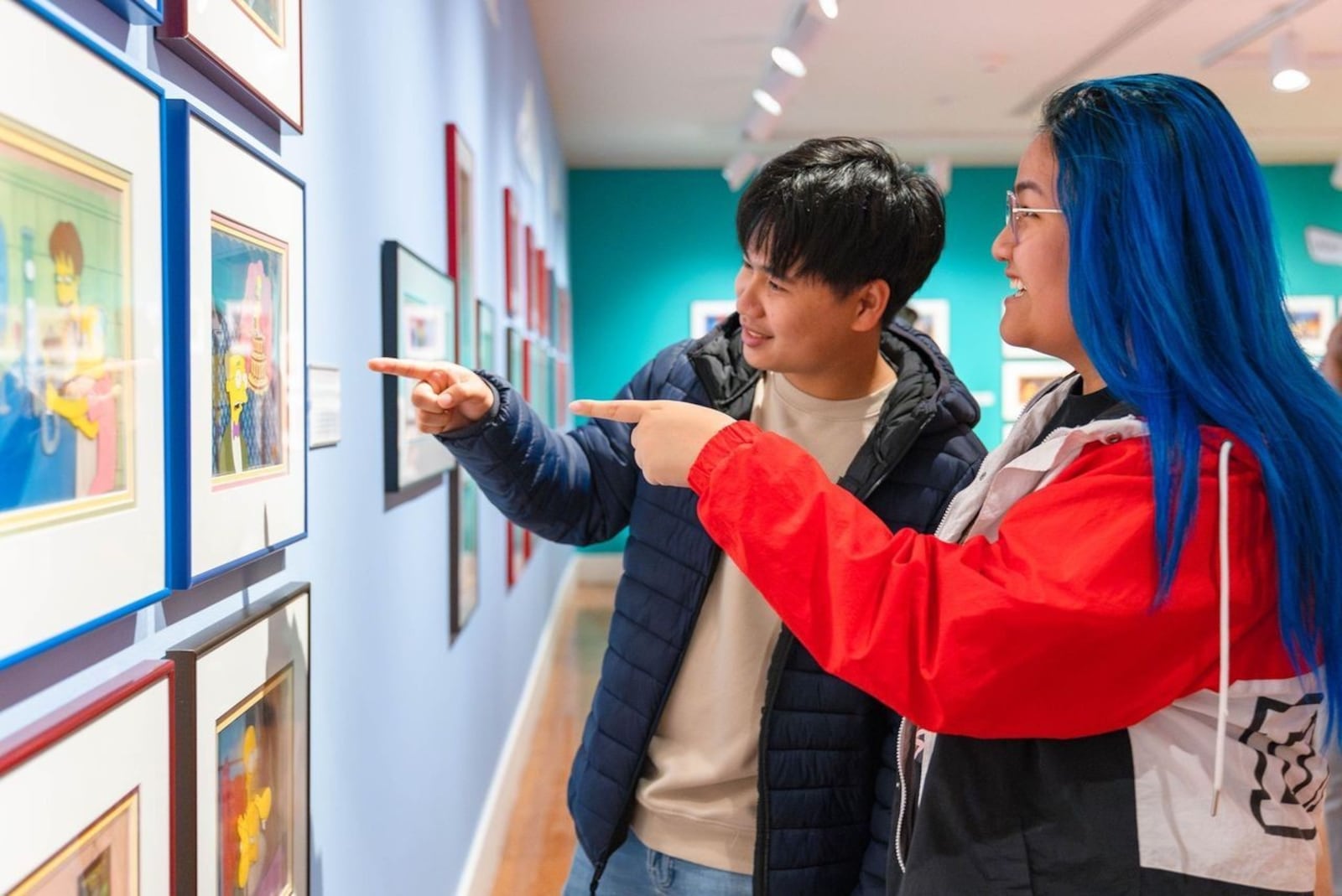Dayton Art Institute patrons explore "Merry Grinchmas: Art of Dr. Seuss’ Holiday Classic & (B)ART! America’s Funniest Animated Family," exhibited earlier this year. CONTRIBUTED