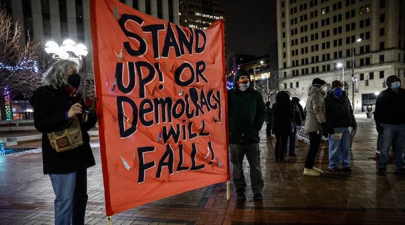 Around 75 people attended a candlelight vigil and rally to remember the January 6 attack on the US capitol at Courthouse Square Thursday night. Jim Noelker/Staff