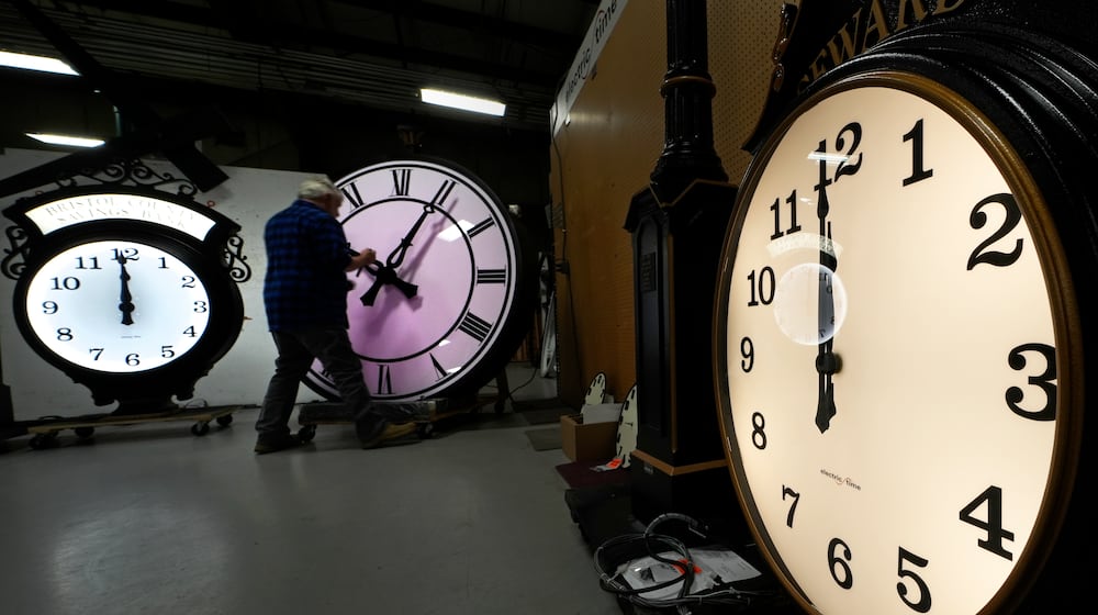 Clockmaker Scott Gow adjusts the hands of a clock at the Electric Time Company, Wednesday, Oct. 30, 2024, in Medfield, Mass. (AP Photo/Charles Krupa)